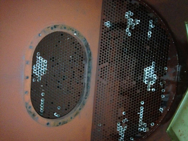 Desuperheater exchanger, image shows the tubesheet where about 400 tubes with greater than 70% surface indications and required repair liners were found. The image also shows tubes marked for repair